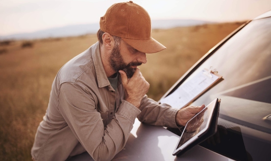 a farmer reviewing his tablet