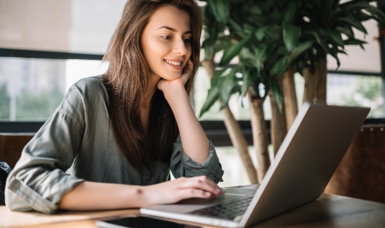 lady smiling while using her laptop