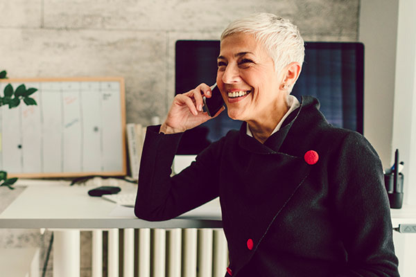 Retiree on the phone and smiling.