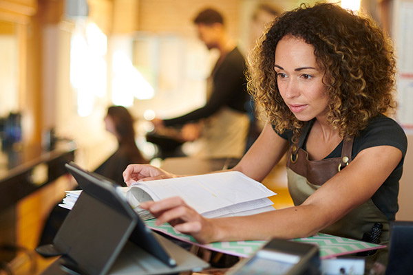 Business person using a tablet to do their financials.