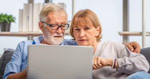 Mature couple viewing a laptop computer
