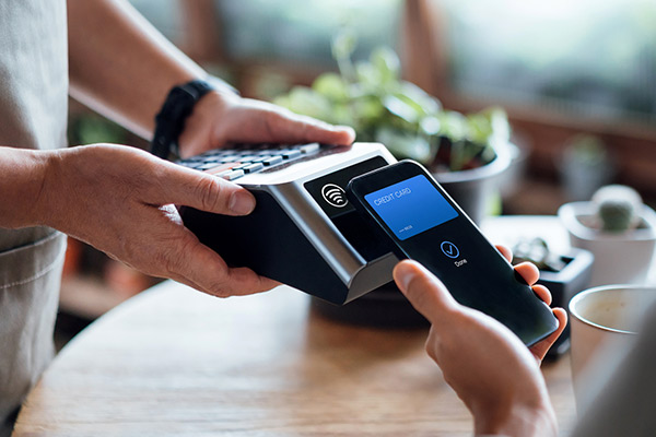 Person using their phone to make a payment for a purchase.