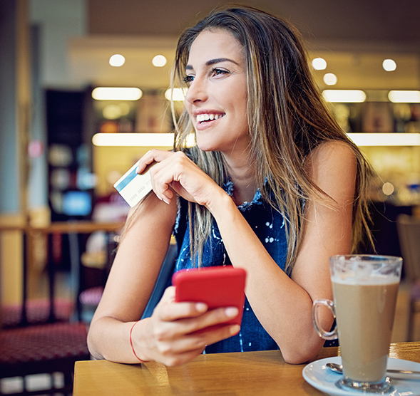 Person using debit card to pay for their coffee.